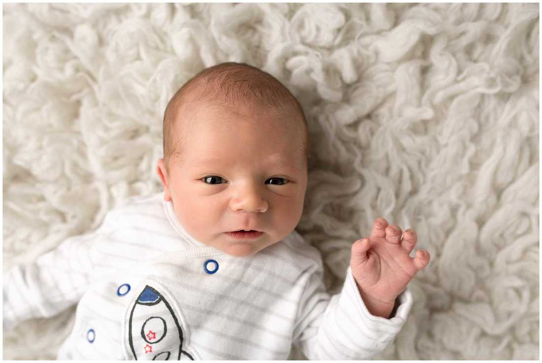 Wide awake picture of newborn baby boy at the end of his newborn photography  session with Lynne Harper