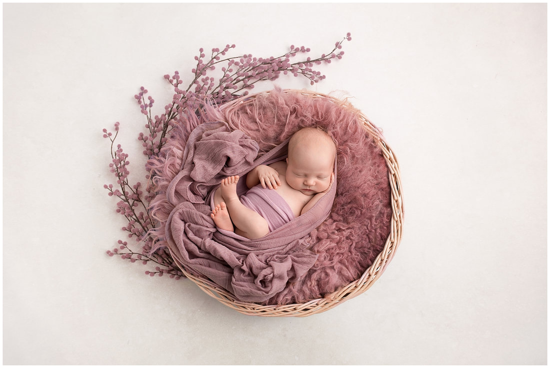 Newborn baby girl in basket, editing using photoshop